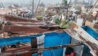 People salvage their belongings in the aftermath of torrential rain and flooding, north of the port city of Durban