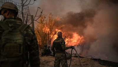 Greece wildfires - latest: Athens seaside town evacuated as strong winds spread deadly fire