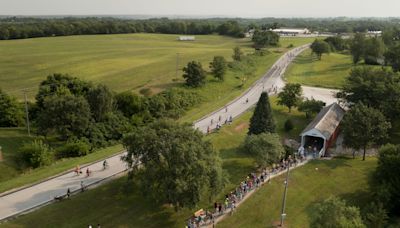 Riders line-up to bike through the Bridges of Madison County on RAGBRAI 2024