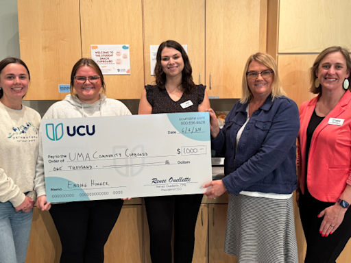 University Credit Union presents checks to University of Maine at Augusta campus food pantries