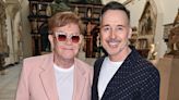 Elton John is supported by husband David Furnish at V&A exhibition