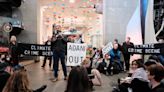 Eco-activists throw black confetti in Science Museum protest