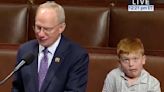 A Child Hilariously Photombomed His Father Speaking On The House Of Representatives Floor, And Now It's Going Super Viral