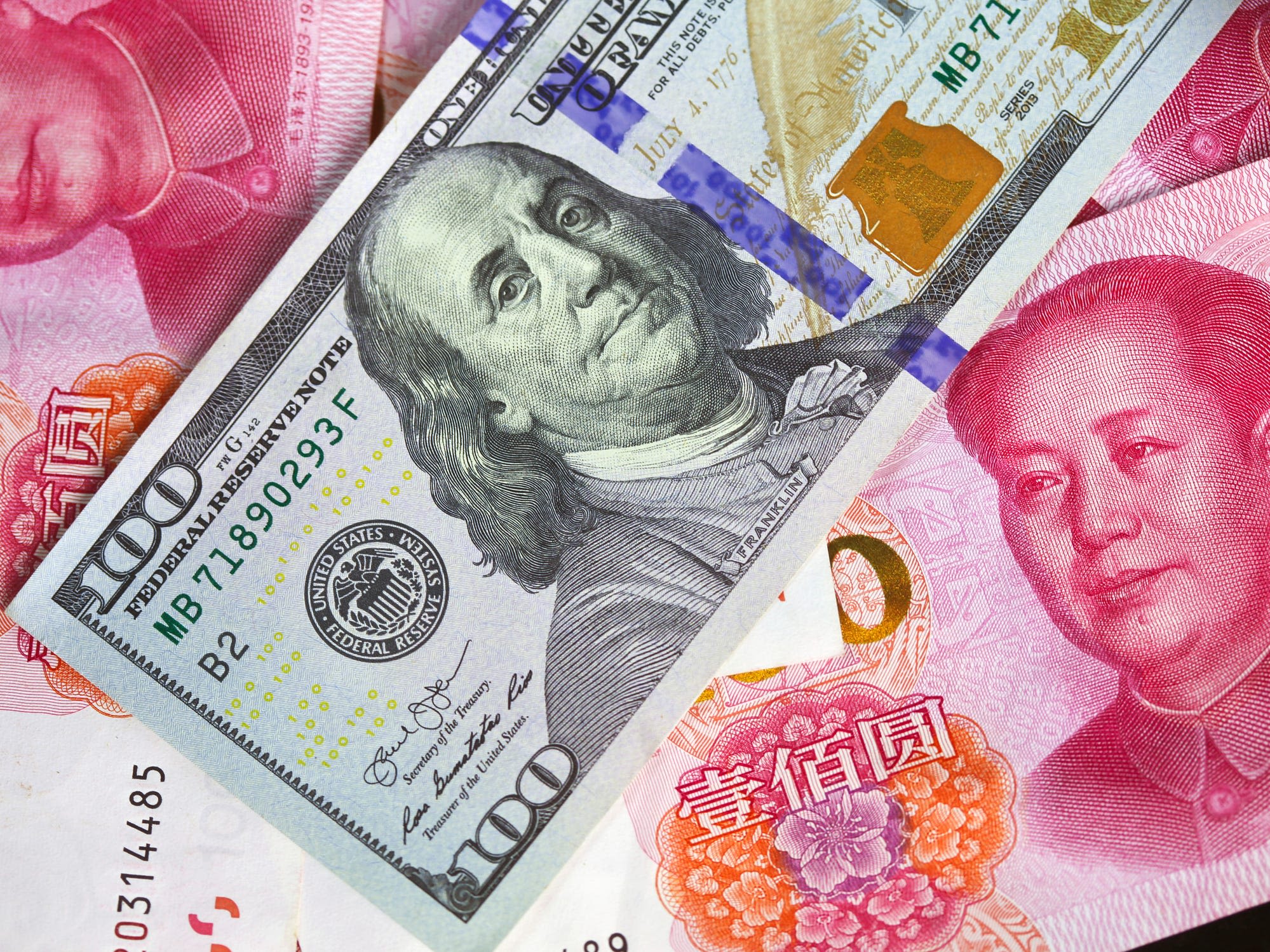 China's yuan is tumbling amid US sanctions and as central banks boost dollar holdings