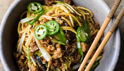 Thinly sliced fried scallions add bold flavor to savory pork noodles