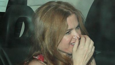 Isla Fisher looks giddy as she gets into awaiting car after event