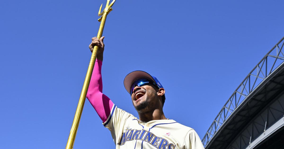 Julio Rodriguez of the Seattle Mariners holds up the team trident after the game against the Oakland Athletics at T-Mobile Park on Sunday, May 12, 2024, in Seattle.