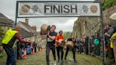 Competitors lug heavy cheese as they race up Hovis Hill famous from ad