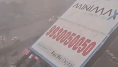 Moment 100ft billboard topples & crushes bystanders as dust storms smash India