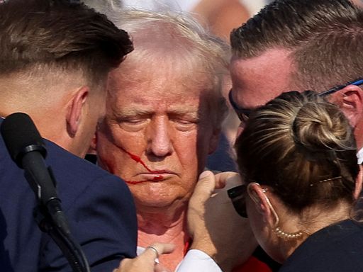 Dramatic photos capture the moments Trump is attacked and rushed off the stage