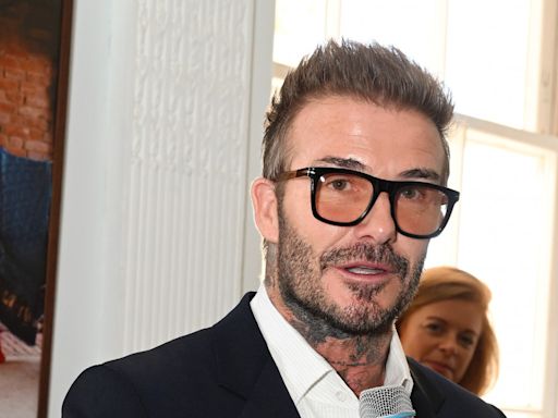 Spexy Becks... David Beckham dazzles as he debuts new specs at London Fashion Week event