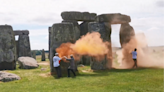 Video: Climate protesters spray orange powder on prehistoric landmark