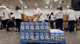 Volunteers pack healthy food for kids in need this summer