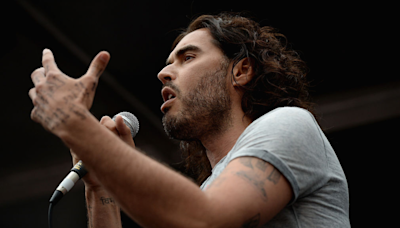 Russell Brand Shares Incredible Photo Captured During His Baptism In The River Thames With Friend Bear Grylls