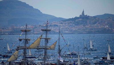 A ship carrying the Olympic torch arrives in Marseille amid fanfare and high security