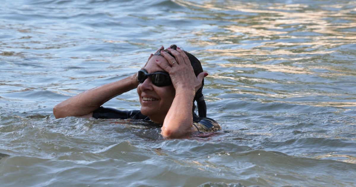 Paris mayor swims in the Seine to show the long-polluted river is clean enough for the Olympics