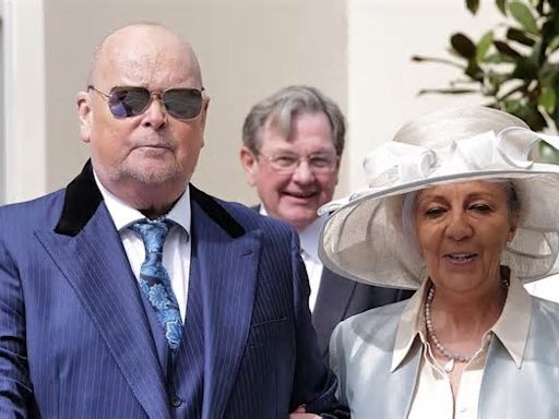 James Whale looks smart as he heads to Windsor Castle to receive his MBE with his wife Nadine by his side - amid his terminal kidney cancer