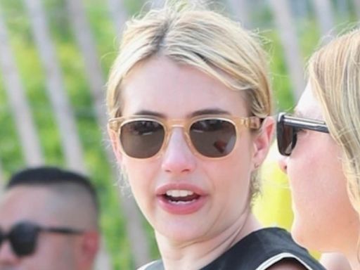 Emma Roberts wears high-heeled booties on the beach at Hamptons bash