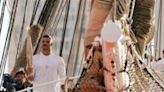 Olympic gold medal-winning swimmer Florent Manaudou holds the Olympic torch on board the 19th century ship that carried it to Marseille