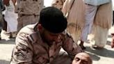 A member of the Saudi security forces helps a pilgrim affected by scorching heat as Muslim pilgrims arrive to perform the symbolic 'stoning of the devil' ritual in Mina