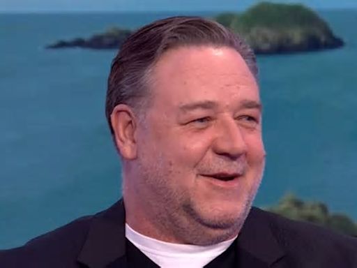 Russell Crowe shocks fans as he's mistaken for John Goodman during a TV appearance after debuting clean-shaven look: 'I wondered who it was!'