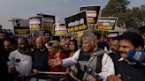 India's opposition lawmakers protest their suspension from Parliament by the government