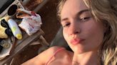 Lily James flaunts her incredible figure in a high cut-pink swimsuit