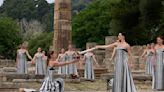 Despite weather glitch, the Paris Olympics flame is lit at the Greek cradle of ancient games