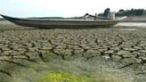 A boat sits on a dried-up reservoir bed in southern Vietnam's Dong Nai province last month