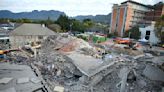 Rescuers contact some workers alive in the rubble of a deadly building collapse in South Africa