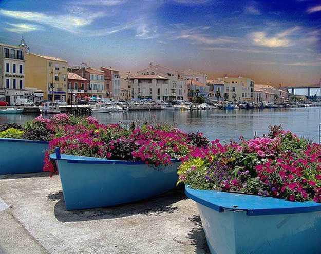 Old boats used as unusual planters for decorating with flowers