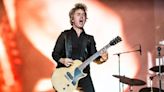 Green Day frontman hoists 'idiot' Trump mask at DC concert