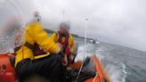 Small boat without power rescued from drifting towards rocks as weather turns