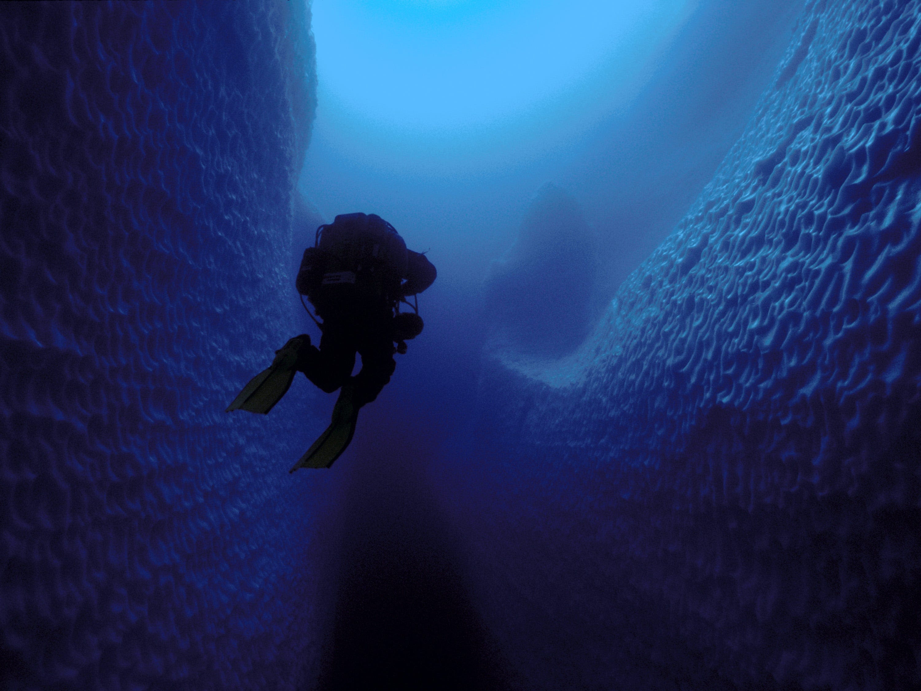 Photos show what cave divers discovered when they swam inside an iceberg the size of Jamaica. Today, it's gone.