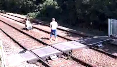 Photoshoot on railway tracks and youths play 'chicken' with trains