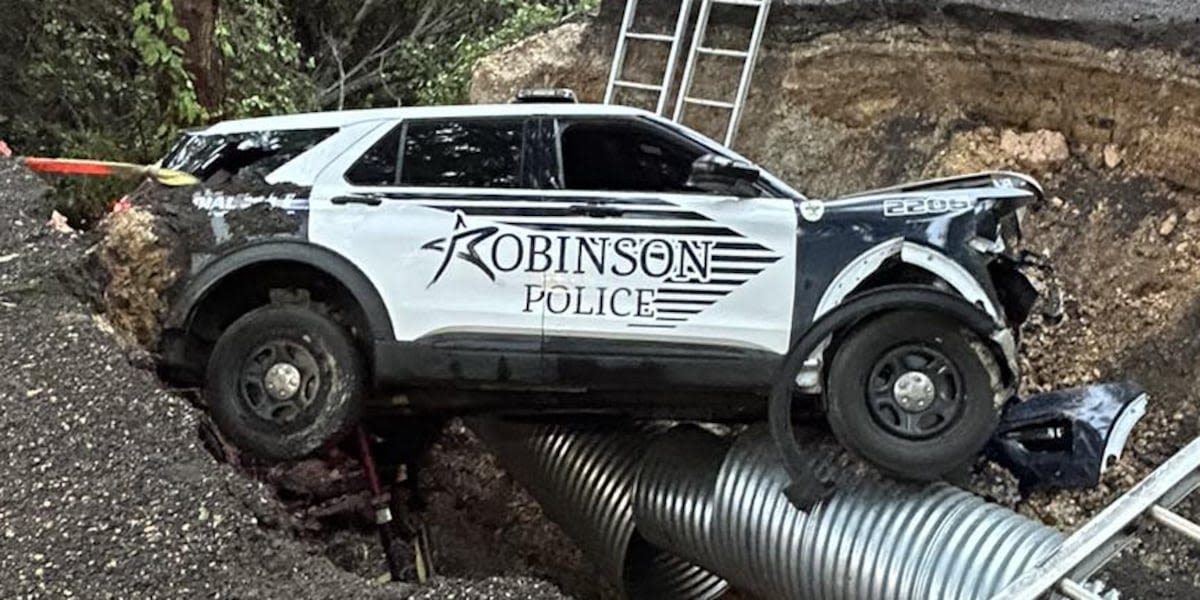 Police officer seriously injured after patrol car falls into sinkhole, authorities say