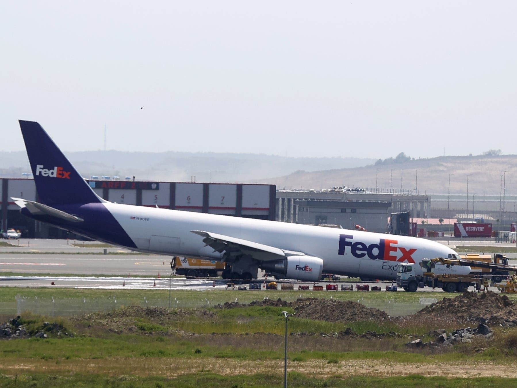 Video shows the scary moment a Boeing cargo plane skidded and threw up sparks when its landing gear failed to deploy properly