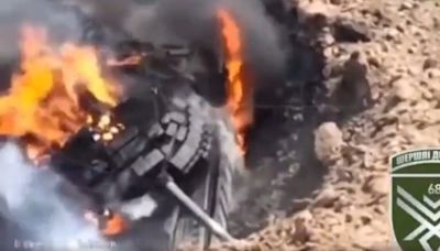 A Russian tank stuck in a large crater became a sitting duck for Ukraine's drones, a video appears to show