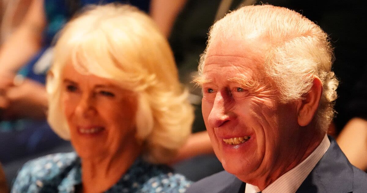 Charles and Camilla giggle as they watch play about family betrayal