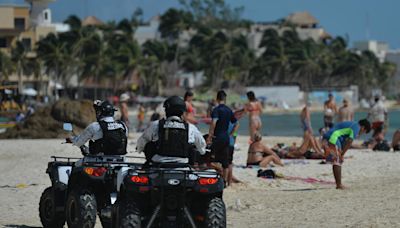 Gunmen on jet skis open fire at rival drug dealer on Cancun beach, killing 12-year-old boy on lounge chair