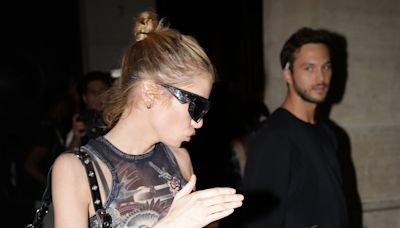 Stella Maxwell leaves her hotel with a mystery man during PFW