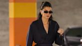 Kendall Jenner Accents Her Quietly Cool Navy Blue Suit With a Bright Orange Bag