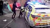 Horror moment police officer is stabbed in neck by passer-by in random attack