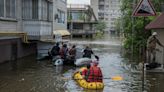 Trapped villagers saved from roofs in flooded south Ukraine as more await help
