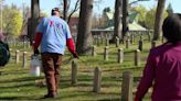 Volunteers clean headstones at Grand Rapids Home for Veterans Memorial Cemetery