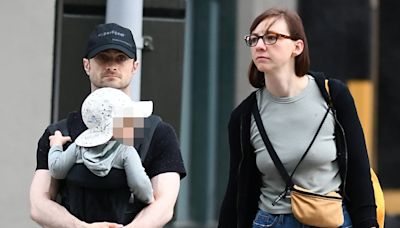 Daniel Radcliffe cradles son on a family walk with partner Erin Darke