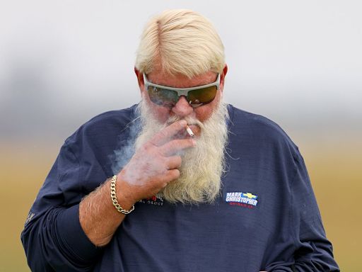 John Daly smokes a cigarette in neon tartan shorts at Royal Troon