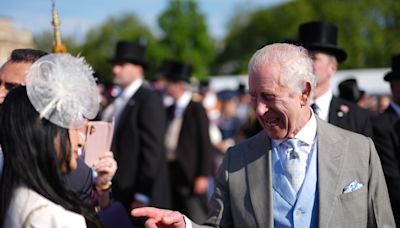 Charles appears in good spirits with guests at Buckingham Palace garden party