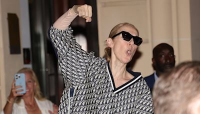 Celine Dion looks in high spirits as she plays air guitar in Paris