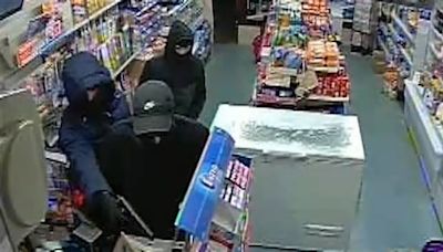 Shocking moment armed thugs point gun at terrified shopkeeper in till raid